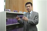 Largan Precision CEO Lin En-ping poses with contact lenses produced by Largan Medical