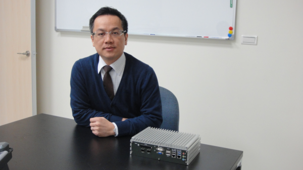 Vecow CEO Eric Yu with the company's ECS-7000 series embedded system boasting a wide temperature range and fanless design.