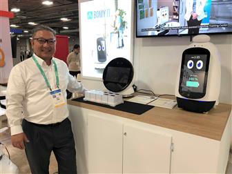 Robocare managing director SH Ahn poses with BOMY I (left) and BOMY II